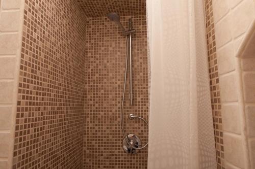 a shower with a shower head in a bathroom at Da Santino in Alberobello