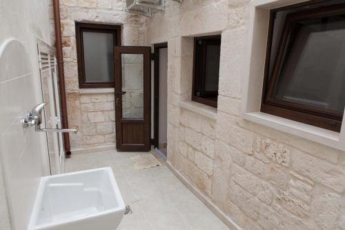 a bathroom with a white sink and a window at Da Santino in Alberobello