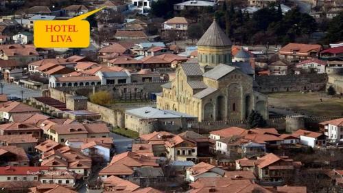 an overhead view of a city with a church and roofs at Hotel Liva in Mtskheta