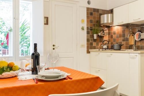 a kitchen with a table with a bottle of wine at Il Cedrangolo House in Monopoli