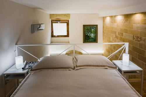 a bedroom with a bed and two night stands at Diletta Casa Vacanze in Lecce