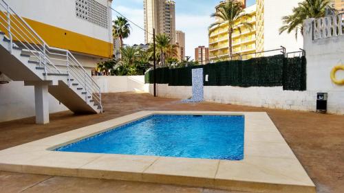a swimming pool in the courtyard of a building at Precioso Apartment Lepanto-Levante in Benidorm