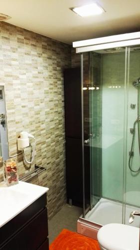 a bathroom with a glass shower and a sink at Precioso Apartment Lepanto-Levante in Benidorm