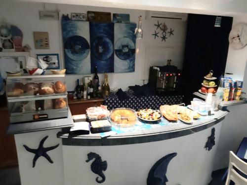 a kitchen with a counter with food on it at Hotel Darsena in Pozzuoli