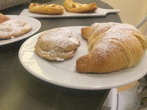 three pastries on a white plate on a table at Ai Tre Mercati in Palermo