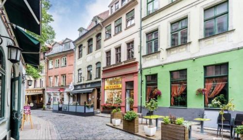 a street in a city with many buildings at Doma square apartment 2, in the heart of Old town in Riga