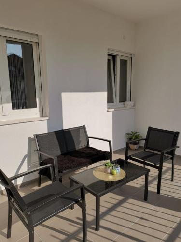 a living room with two chairs and a table at AMI in Solin