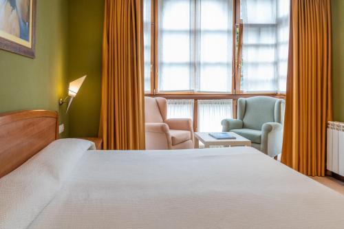 Katil atau katil-katil dalam bilik di Gran Hotel Rural Cela