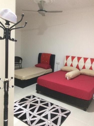 a living room with two beds and a lamp at Sesuci Murni Homestay in Tanah Merah