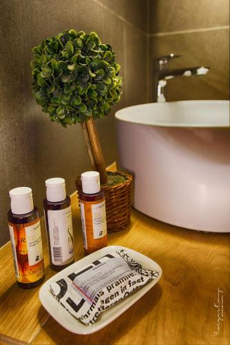 a bathroom with a sink and some medicines on a table at Castro Sunset Stories in Neos Marmaras