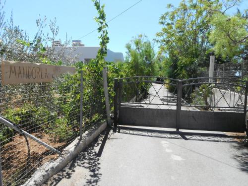 a gate at the entrance to a zoo at Mandorla Apartments in Lardos