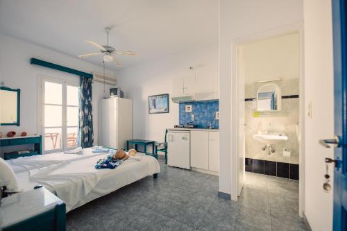 a bedroom with a bed and a bathroom with a sink at Villa Anna Maria in Aliki