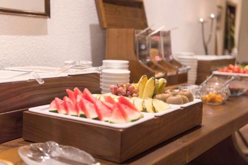 a table with a tray of fruit on a counter at "Quality Hosts Arlberg Hotel Garni Mössmer" in Sankt Anton am Arlberg
