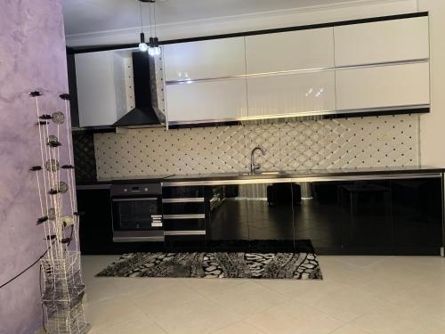 a kitchen with a sink and a counter top at Marinela Apartment in Sarandë