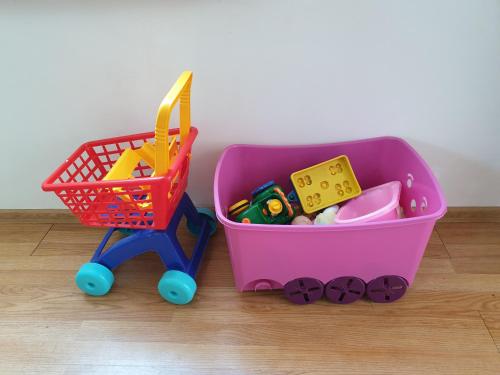 a toy shopping cart and a toy shopping basket at Apartmány Centro & Jacuzzi in Piešťany