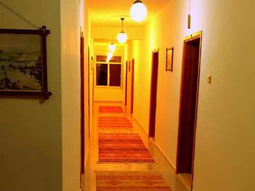 a hallway with a long wooden floor in a house at Patara Caretta Hotel in Patara