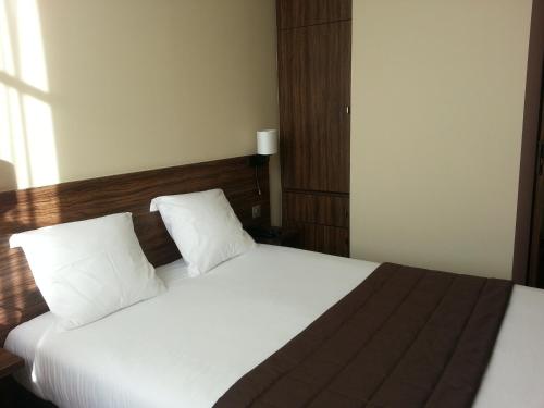 Кровать или кровати в номере Hotel Vauban