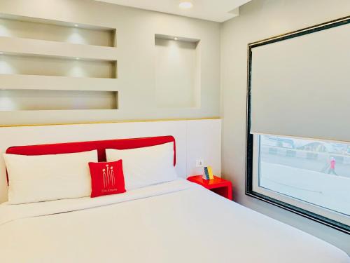 a bedroom with a bed and a large window at City Empire New Delhi Train Station in New Delhi