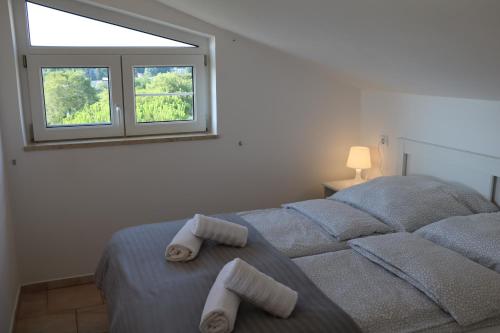 a bedroom with a bed with towels on it at Villa Kiki in Rovinj