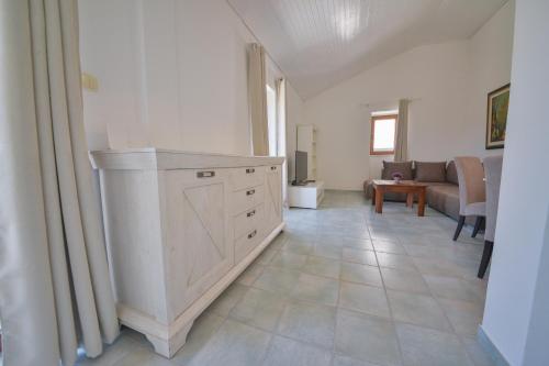a living room with a counter and a couch at Kazanegra Exclusive Apartments in Sveti Stefan