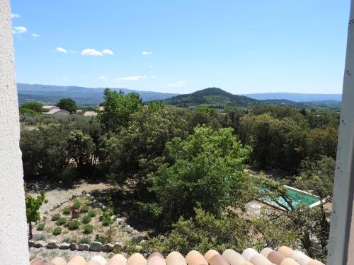 a view of a garden from a window at Le Mas de l'Escaillon in Saint-Saturnin-les-Apt