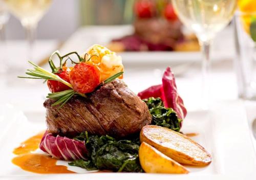 a plate of food with a piece of meat and vegetables at Ringhotel Roggenland in Waldeck