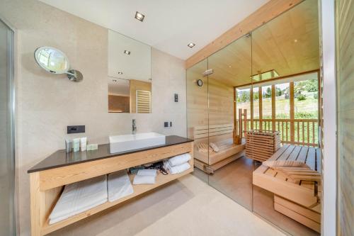 a bathroom with a sink and a mirror at Nature Hotel Delta in Colfosco