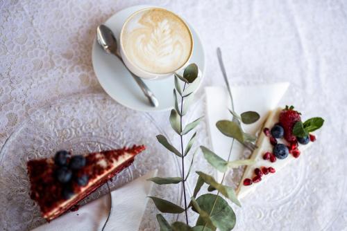 a plate of food with a cup of coffee and a dessert at Hotel MAGISTR Vsetín in Vsetín