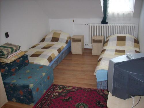 A bed or beds in a room at Fanni Vendégház