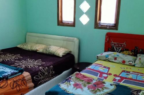 Tempat tidur dalam kamar di Homestay Mbak Sulis Bromo