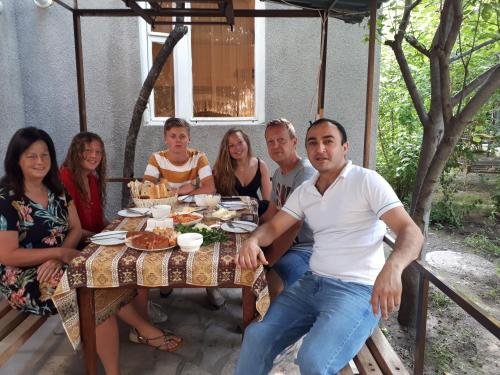 a group of people sitting around a table at Narek B&B in Goris