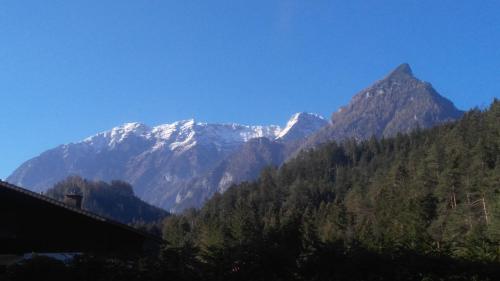 a mountain with snow capped mountains in the distance at Rulfik in Hinterberg