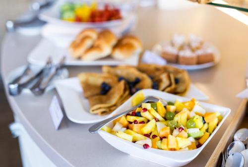 a buffet with plates of food on a table at Hotel MAGISTR Vsetín in Vsetín