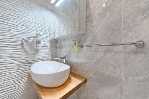 a bathroom with a white sink and a mirror at Hotel Trogirski Dvori in Trogir