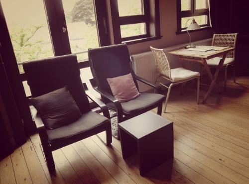 a room with two chairs and a table and a table and window at B&B Lieven Bauwens in Ghent