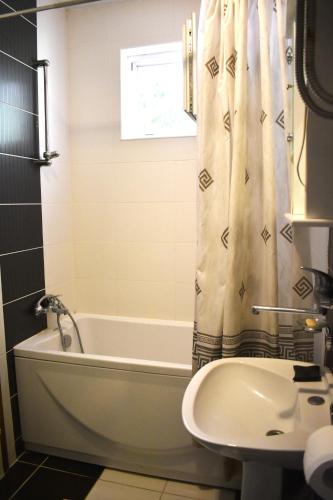 a bathroom with a tub and a toilet and a sink at Apartments Montenegro Risan Čučković in Risan
