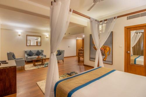 a bedroom with a bed and a living room at 8fold by LaRiSa in Shimla