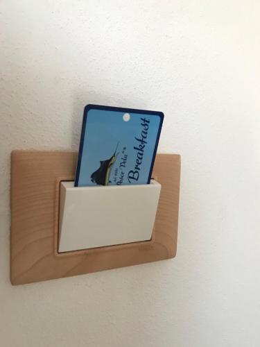 a book on a shelf with a laptop on it at B&B "al Pesce Vela" in Albese Con Cassano