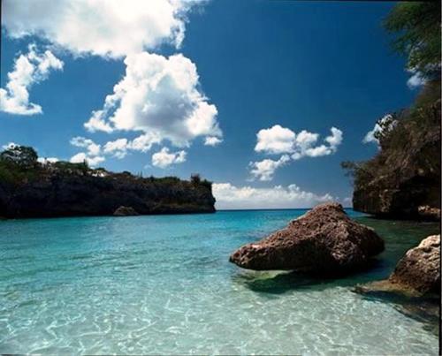 a view of the ocean with rocks in the water at My Dream Apartments in Lagun