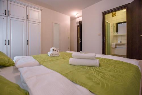 a bedroom with a large bed with towels on it at Mare E Sabbia in Lopar
