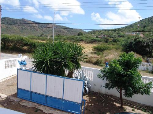 a blue and white fence on the side of a road at My Dream Apartments in Lagun