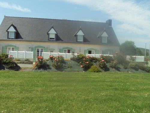 a large house with a lawn in front of it at Gîtes du Ménez-Hom in Plomodiern