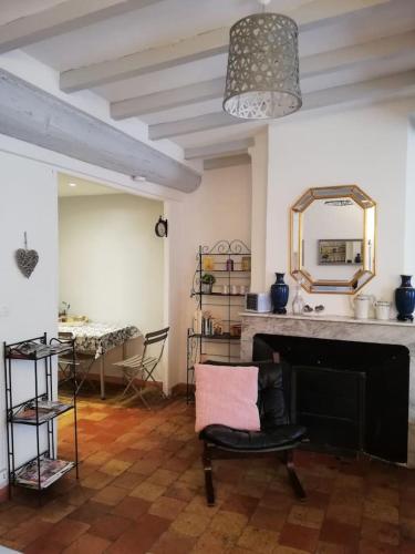 un salon avec une cheminée et un miroir dans l'établissement Studio ensoleillé, typique centre historique, wifi, à Aix-en-Provence