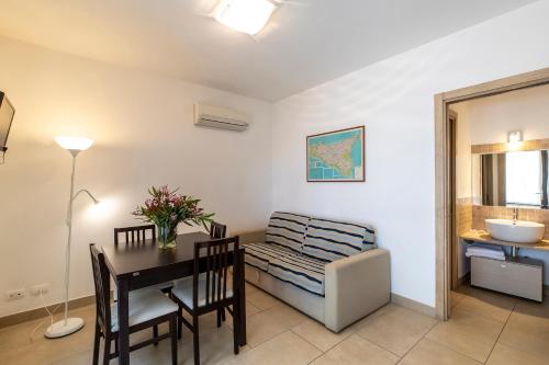 a dining room with a table and a sink at Il Borgo Del Principino in Favignana