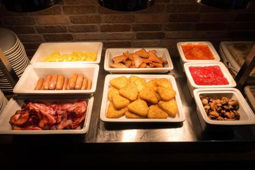 a table with several trays of different types of food at The Kings Cross Hotel in Blackpool