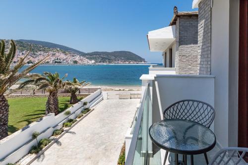 a balcony with a table and a view of the ocean at Olia Green Residence in Skopelos Town