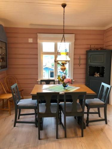 uma sala de jantar com uma mesa de madeira e cadeiras em Charming Lakeside House em Lillehammer