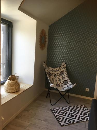 a room with a chair and a window at Berlingot in Amboise