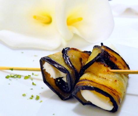 a piece of food on a white plate with chopsticks at Goiko-Benta Ostatua in Oñate