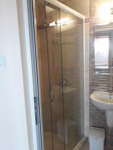 a bathroom with a shower and a sink at Dom Shtakovi in Pomorie